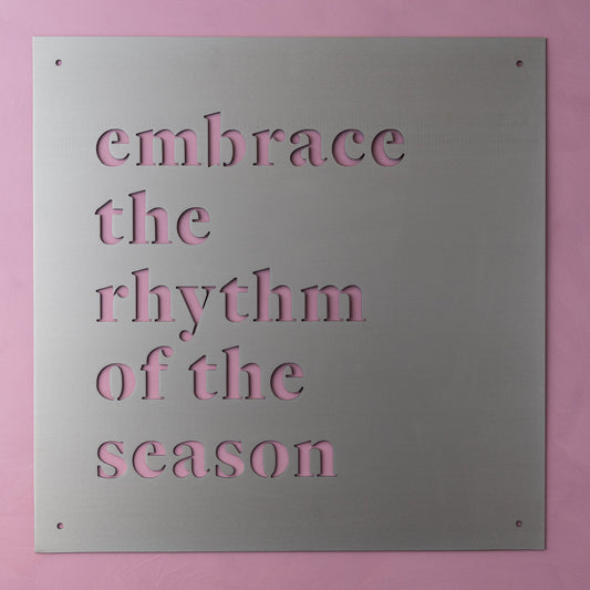 metal wall sign that reads "embrace the rhythm of the season"